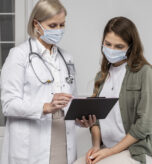 medium-shot-doctor-patient-wearing-masks