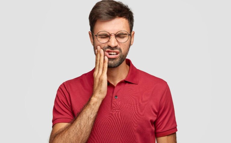 Person experiencing teeth grinding (bruxism) at night while sleeping.