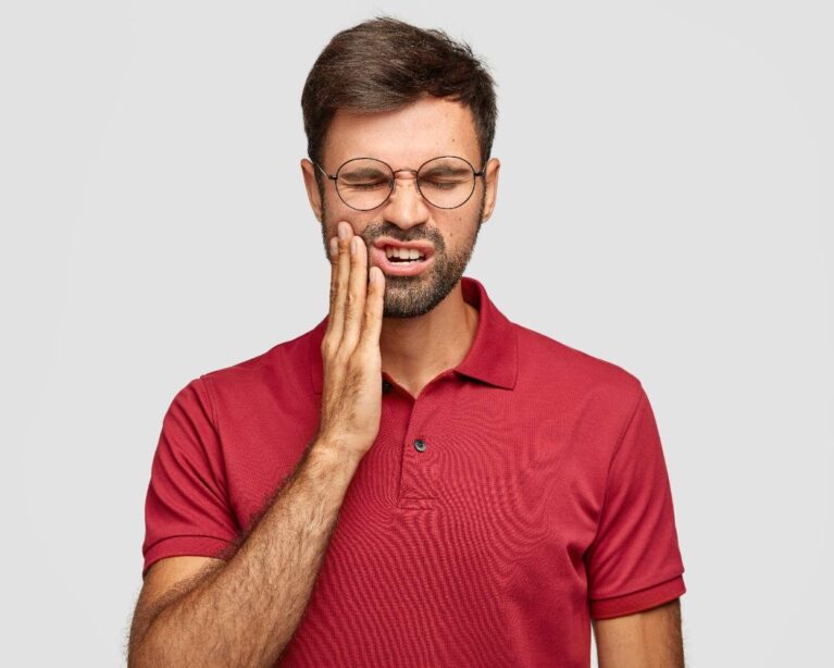 Person experiencing teeth grinding (bruxism) at night while sleeping.