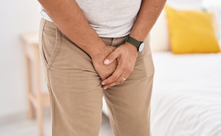 Person experiencing symptoms of a urinary tract infection and consulting a doctor.