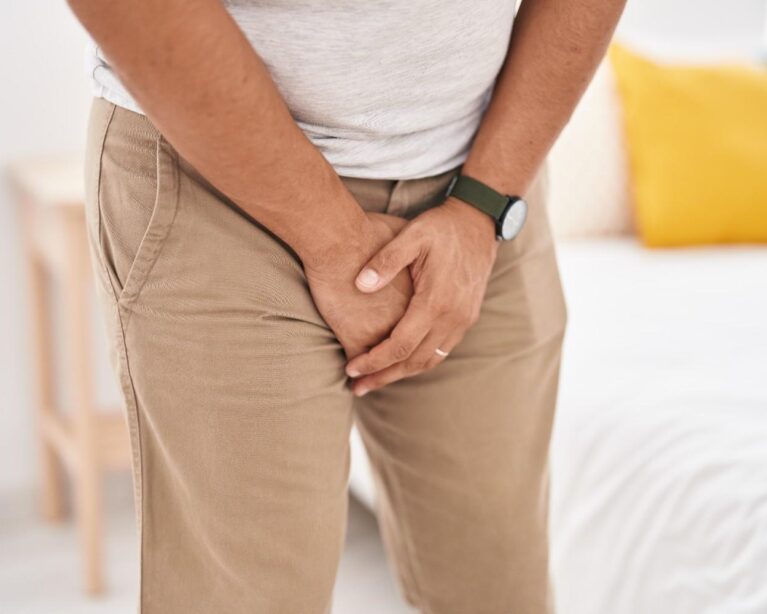 Person experiencing symptoms of a urinary tract infection and consulting a doctor.