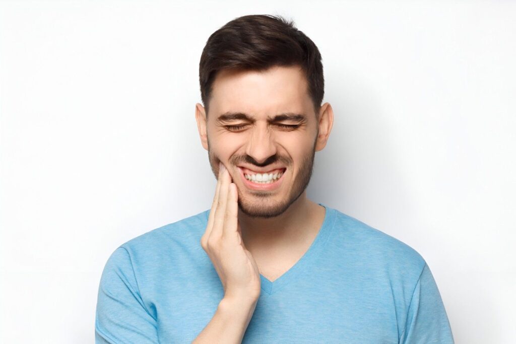 Person experiencing teeth grinding (bruxism) at night while sleeping.