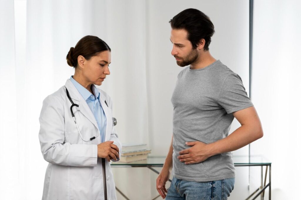 Doctor examining a patient for hernia symptoms