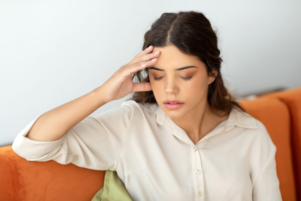 Woman experiencing migraine headache symptoms